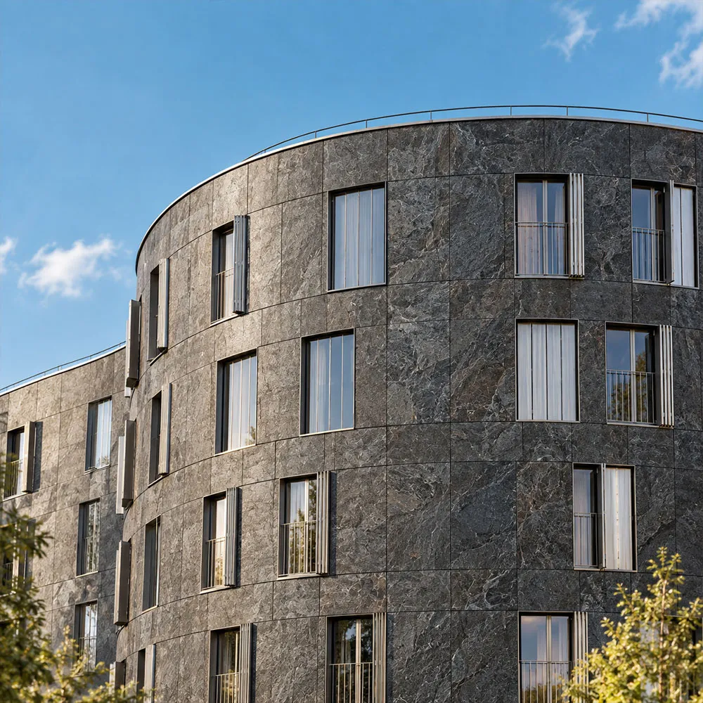 Curved building facade clad in dark stone veneer